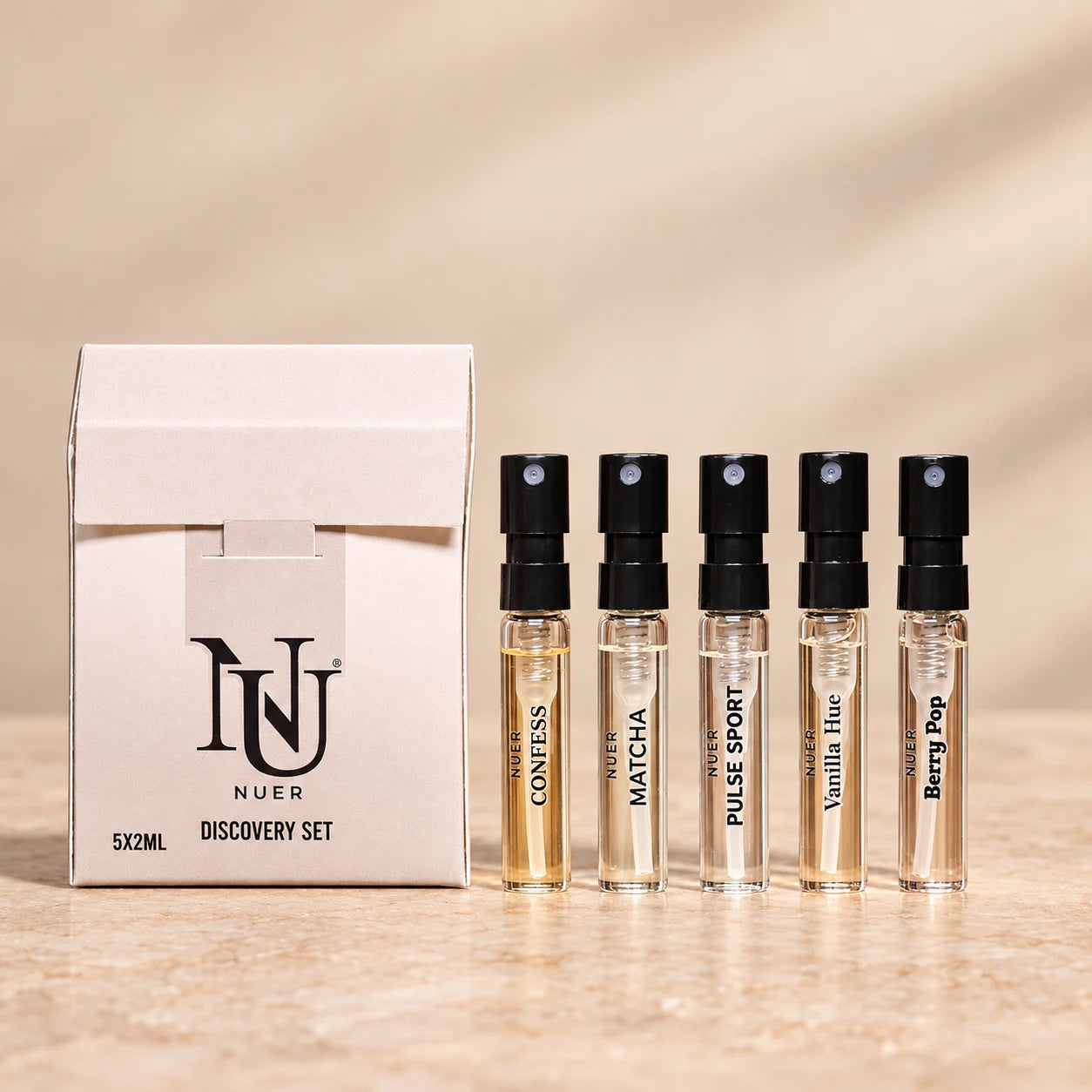 NUER Tester Kit For Her: a white discovery carton and five 2 ml fragrance spray vials.